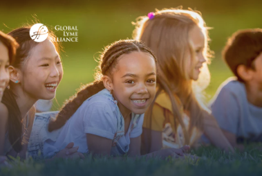 Little kids smiling in grass